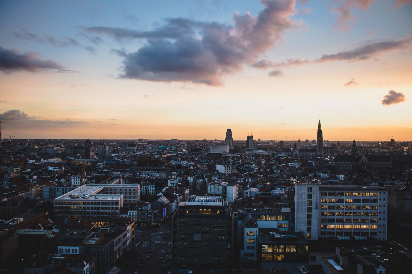 De skyline van Antwerpen onder een avondlucht